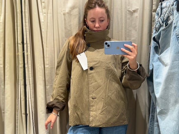 Lucy wearing the jacket in a Zara changeroom.