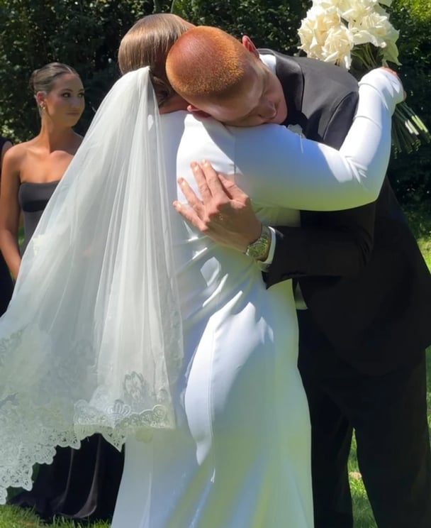 Chloe and Toby Pink embrace on their wedding d