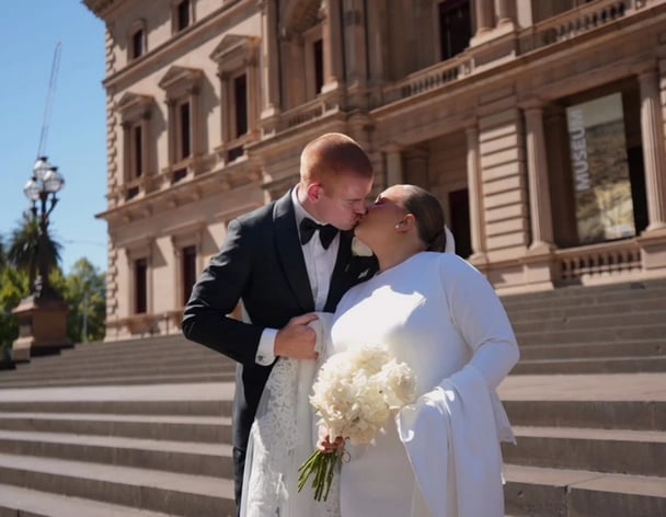 Chloe and Toby Pink kiss on their wedding day