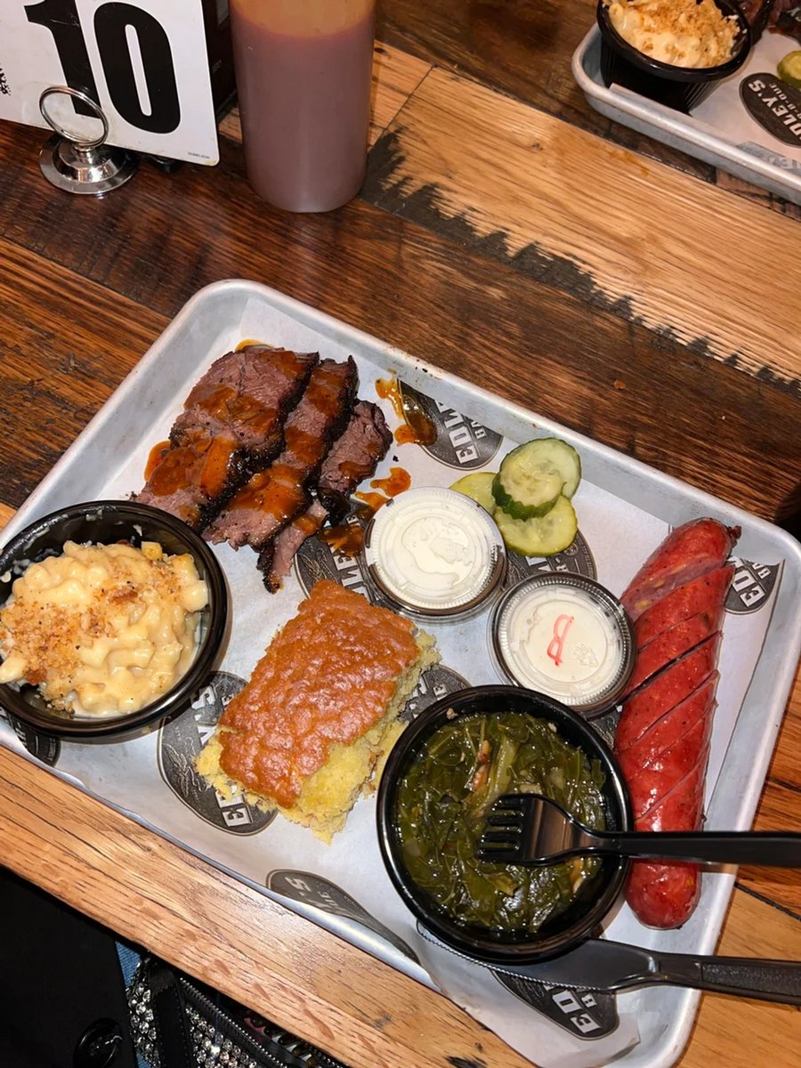 A BBQ brisket platter featuring mac and cheese, collard greens and conbread from Edley's Bar-B-Que.