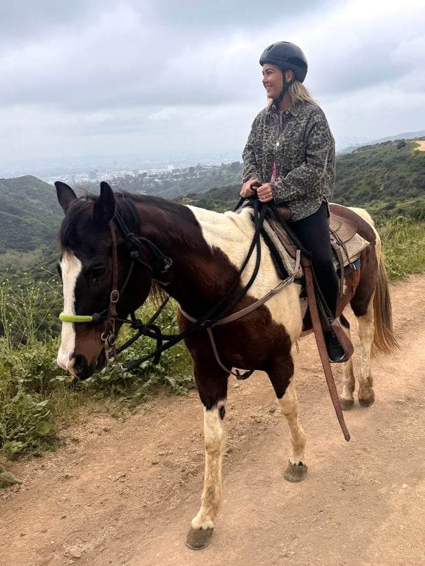 Sasha riding horseback.