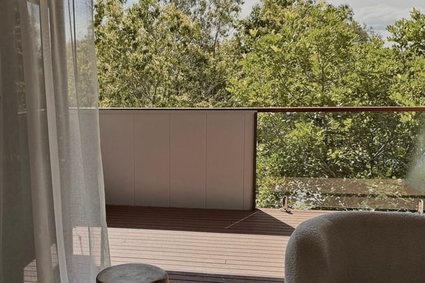 The home has a view of trees out a balcony. Image: Supplied.