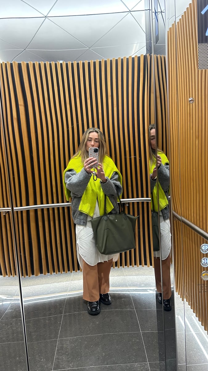 Author shows how she layers a dress over pants.