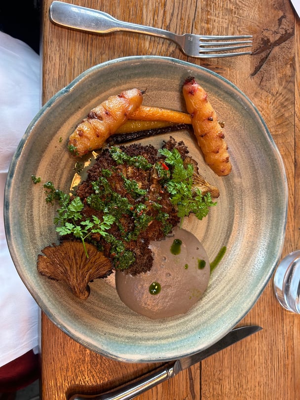 A meal on a rustic pottery place, on a wooden table. 