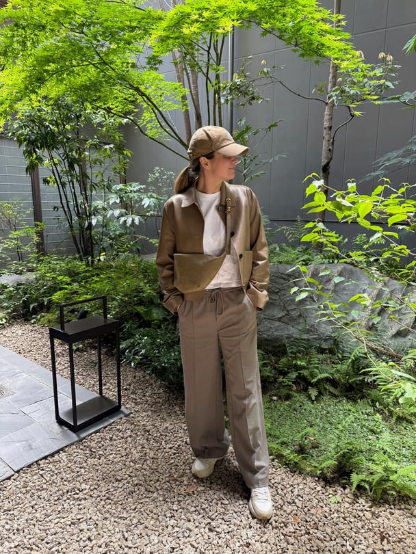 Paige in a full khaki-coloured outfit outside in Japan.