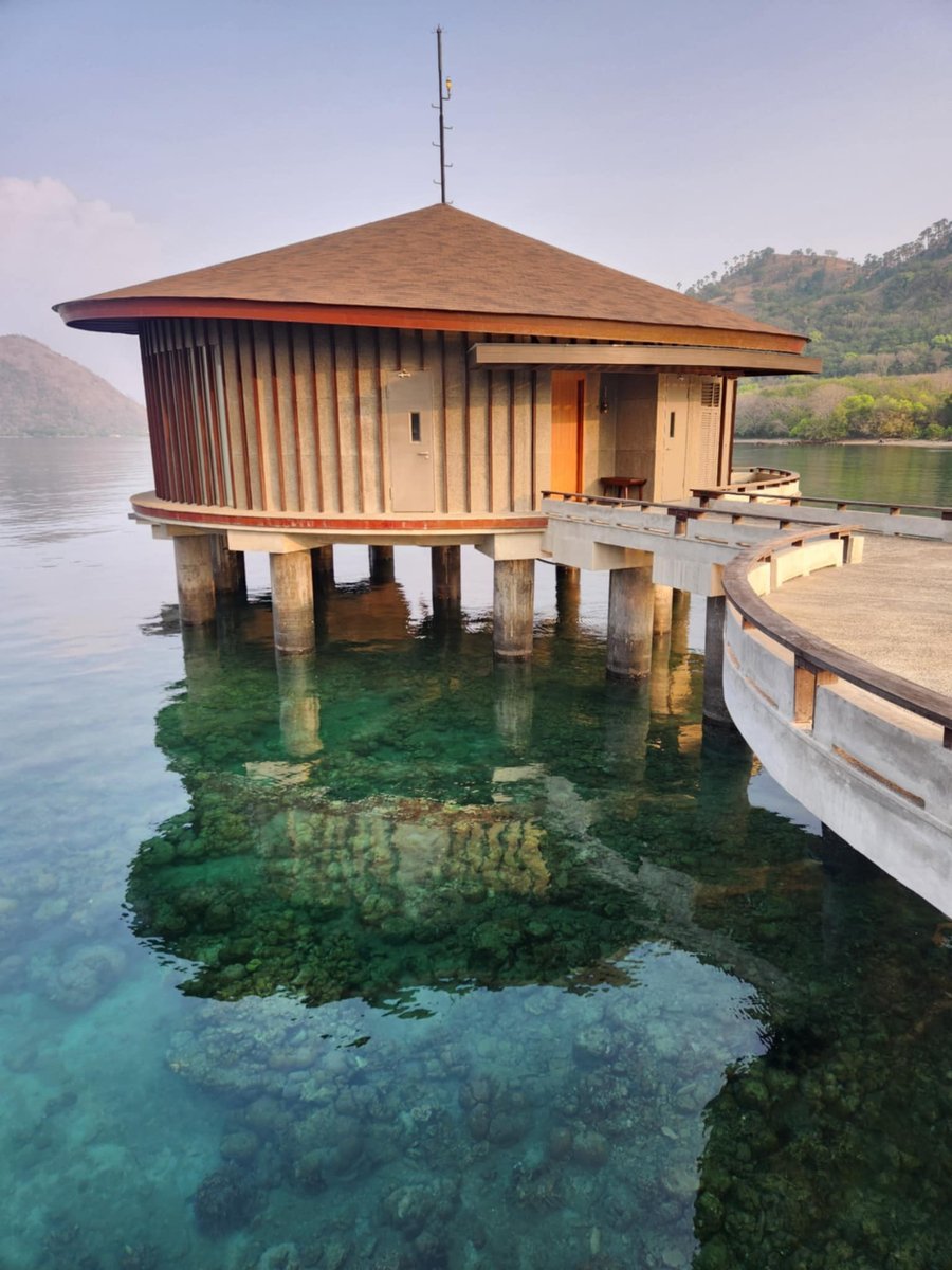 The bamboo huts in Flores, overlooking water.