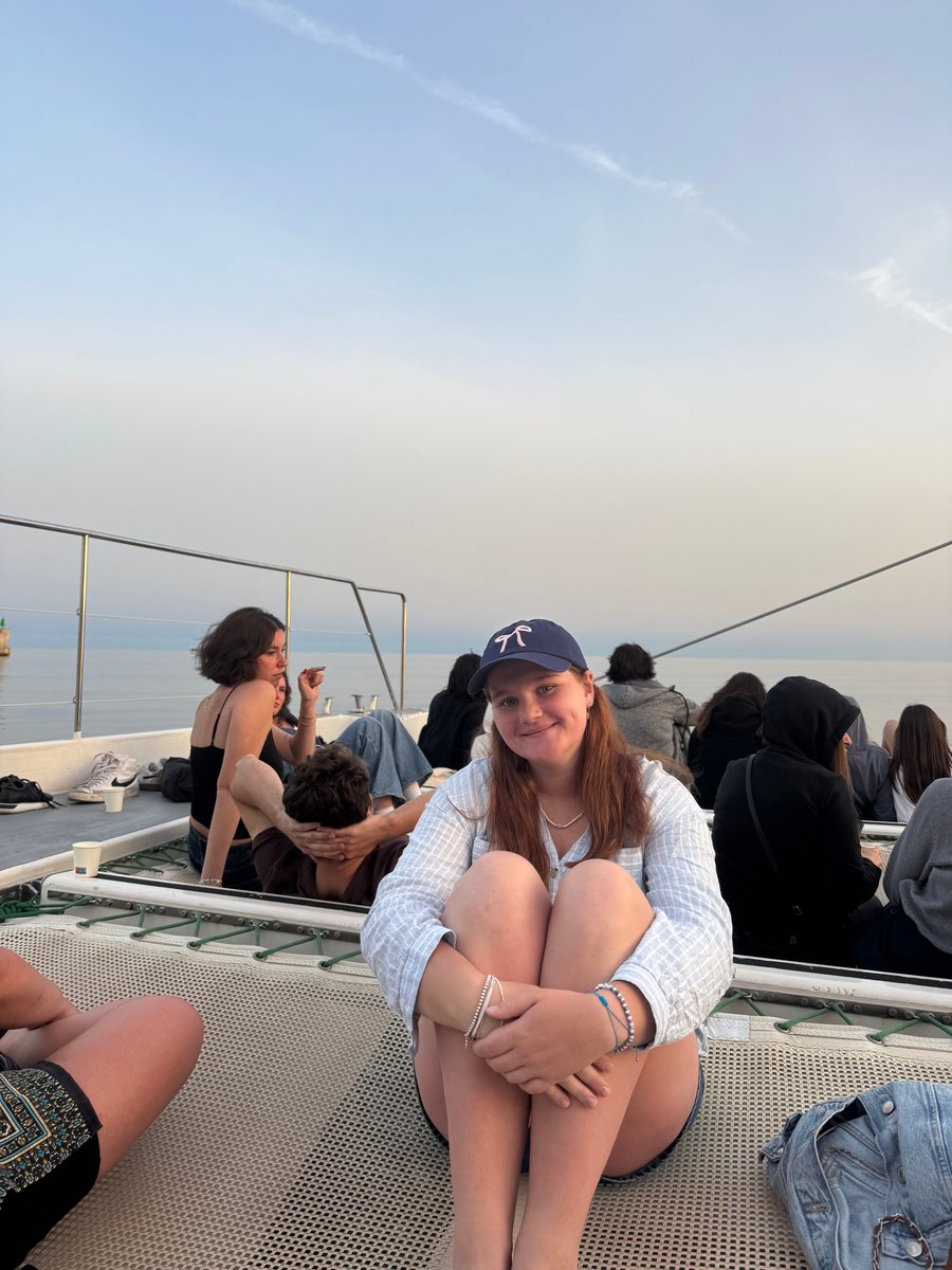 A girl sitting on a travel boat.