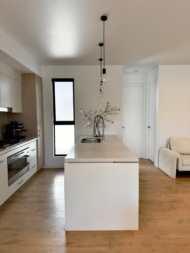 The kitchen is white and minimal.