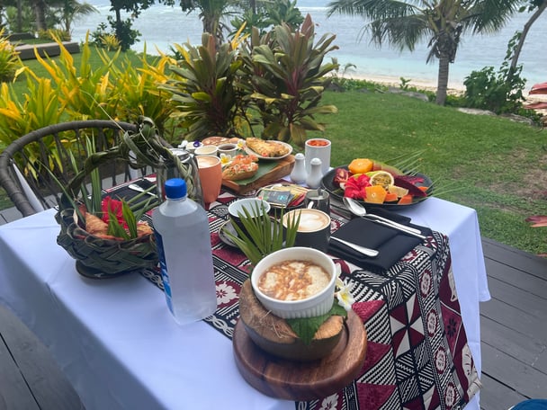 breakfast food on a table on the beach