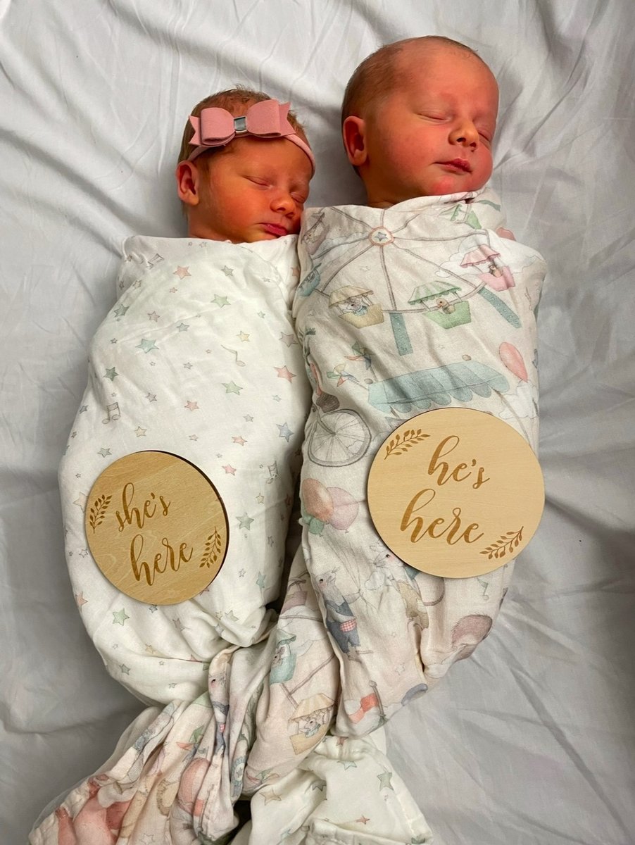 Twin babies are swaddled with 