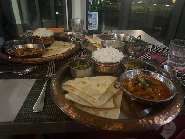 silver trays of Indian-fusion food on a table in a restaurant