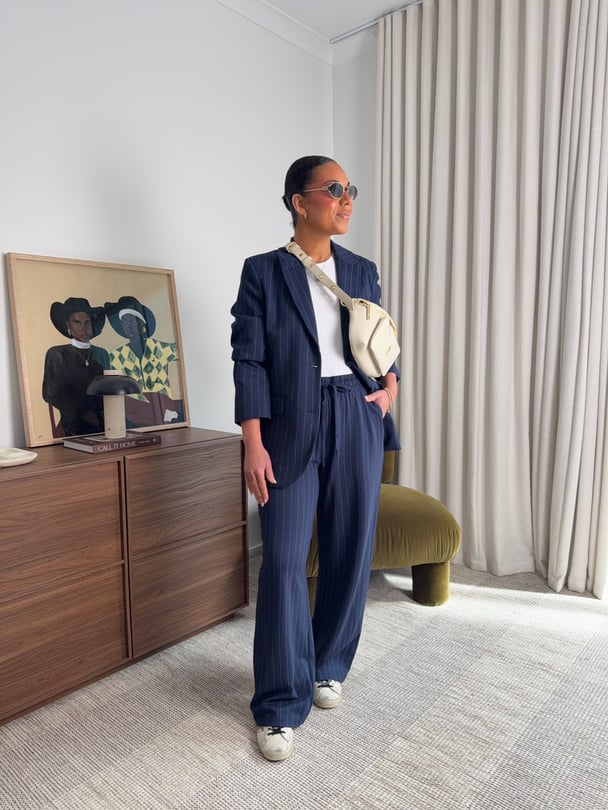 Stylist Emelia Morris wears a navy pinstripe pantsuit.