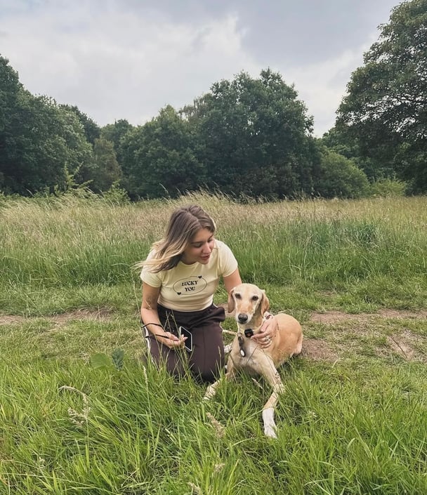 Rebecca with her dog on a walk outside.