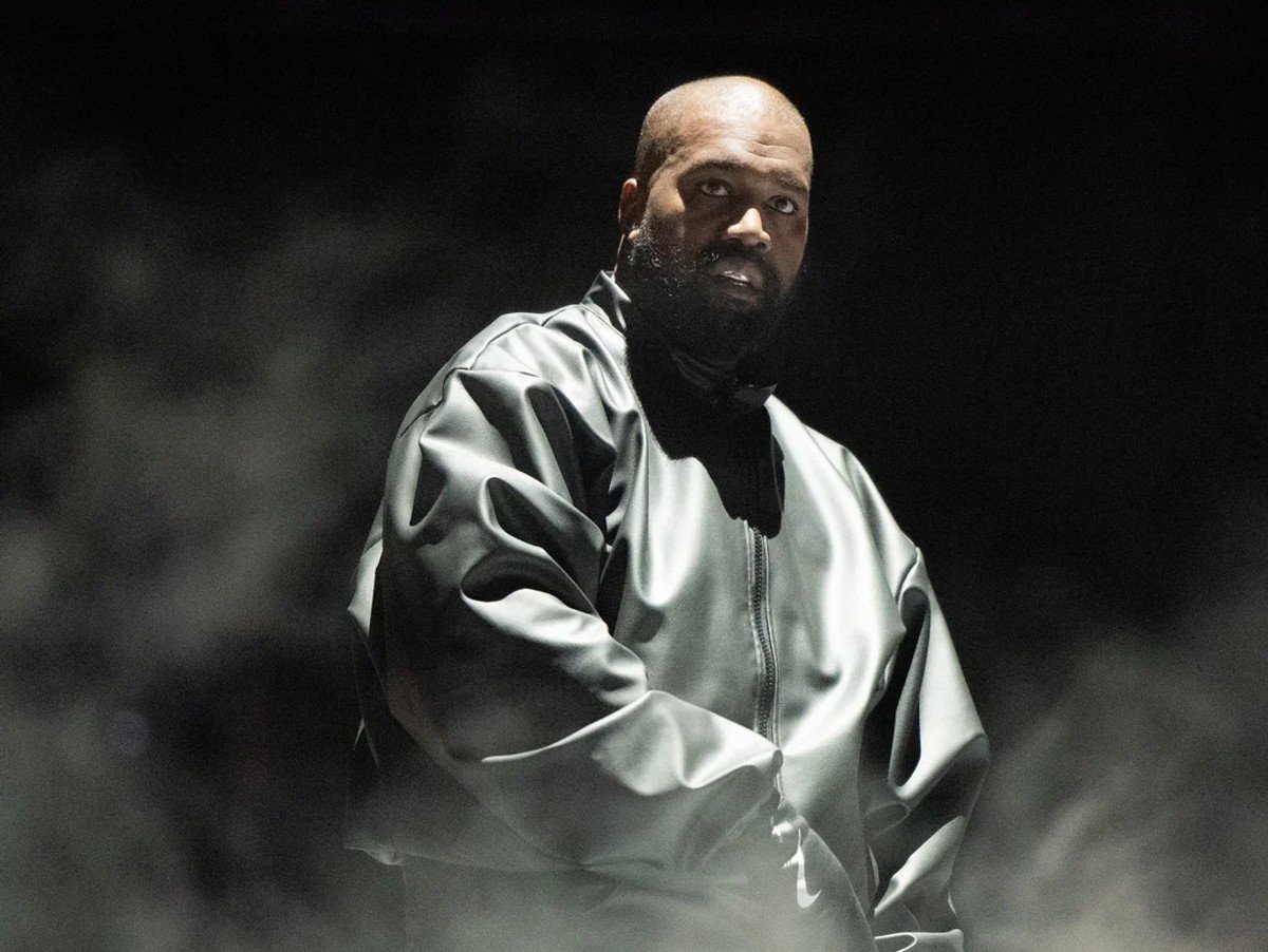 Rapper Kanye West wearing black jacket as he performs onstage during the 