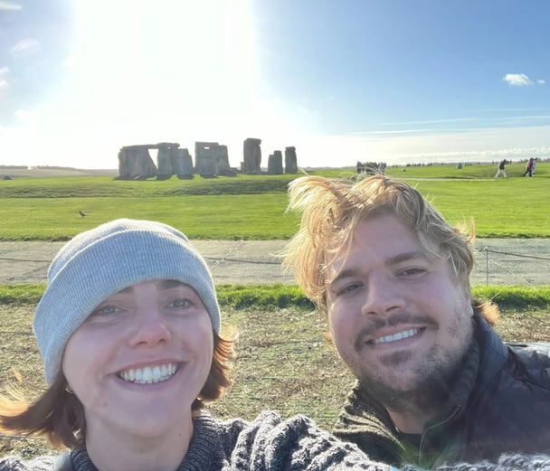 woman and man standing in front of Stone Henge