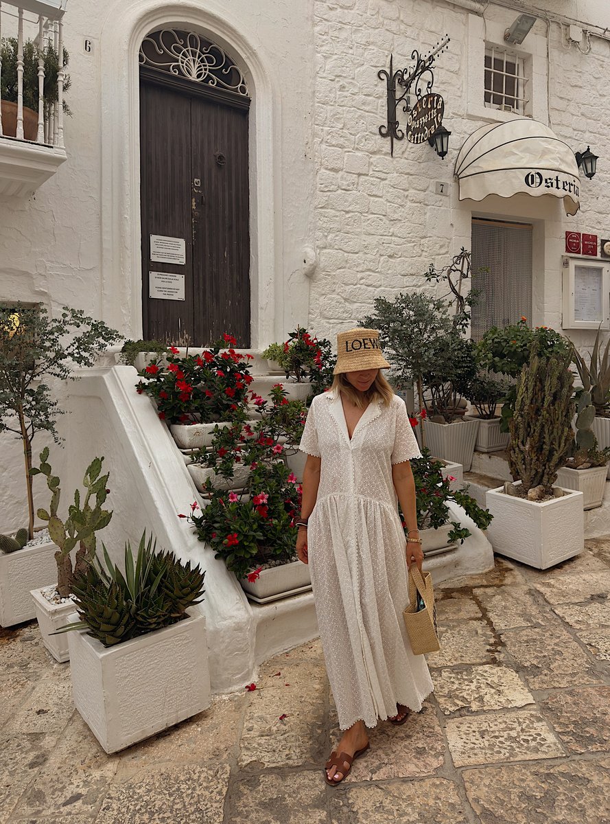 Author wearing a sheer collared dress on holiday in Europe.