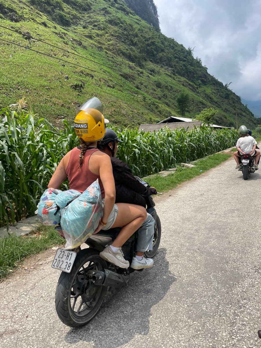 Sarah pictured on the back of a moped.
