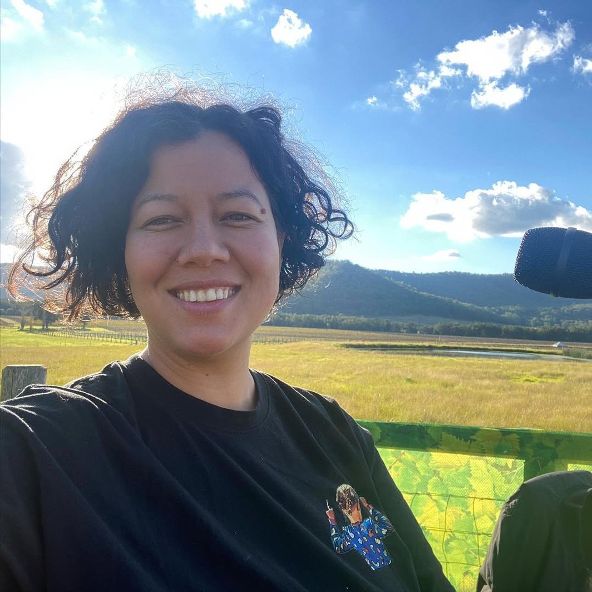 mahalia-barnes-with-microphone-on-a-field