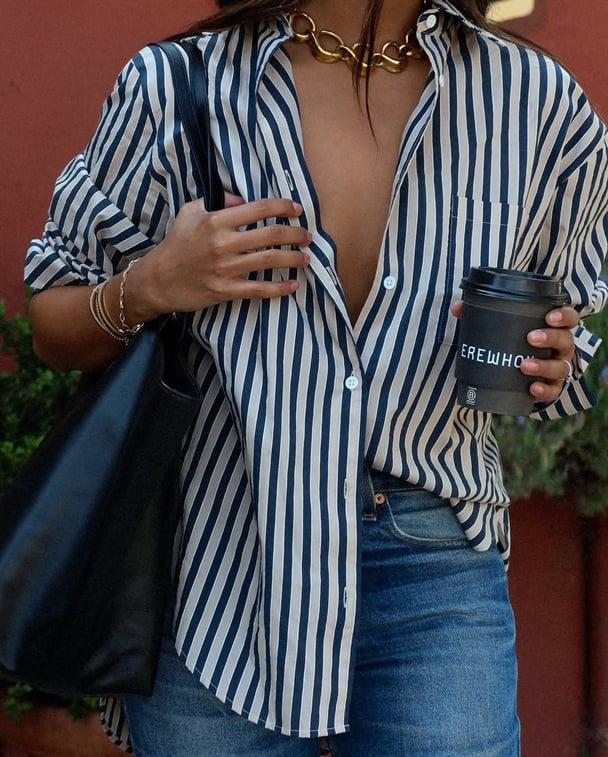 A style image of a striped shirt half tucked into jeans.