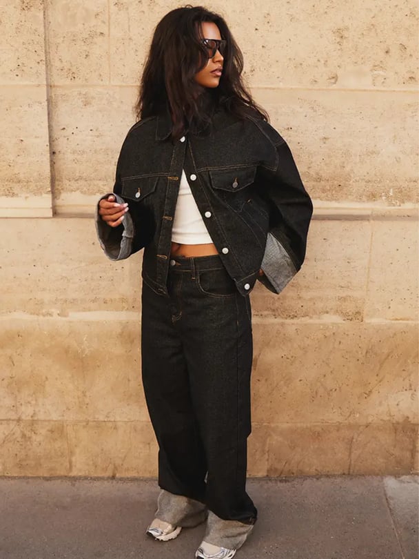 Woman wearing an oversized, boxy denim jacket with a traditional collar and white button-down front with matching high-waisted, wide-leg boyfriend jean from Pretty Little Thing.