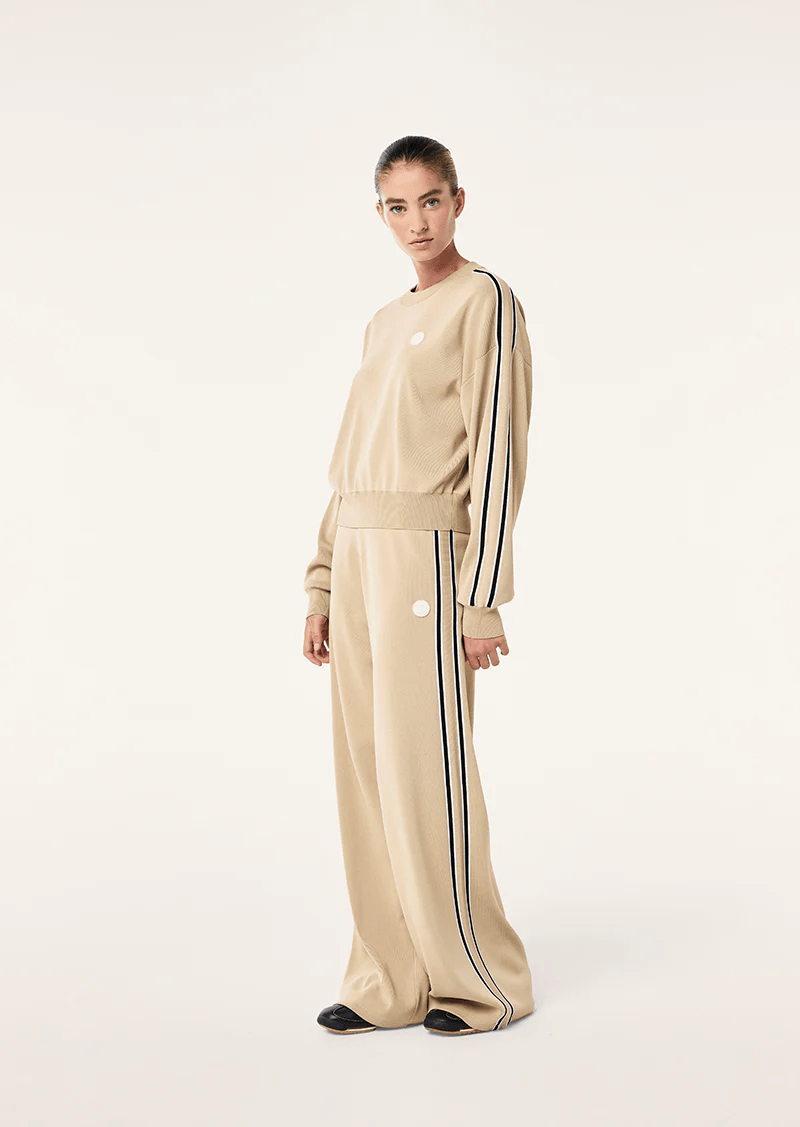 woman wearing knit top and pants in tan from P.E Nation