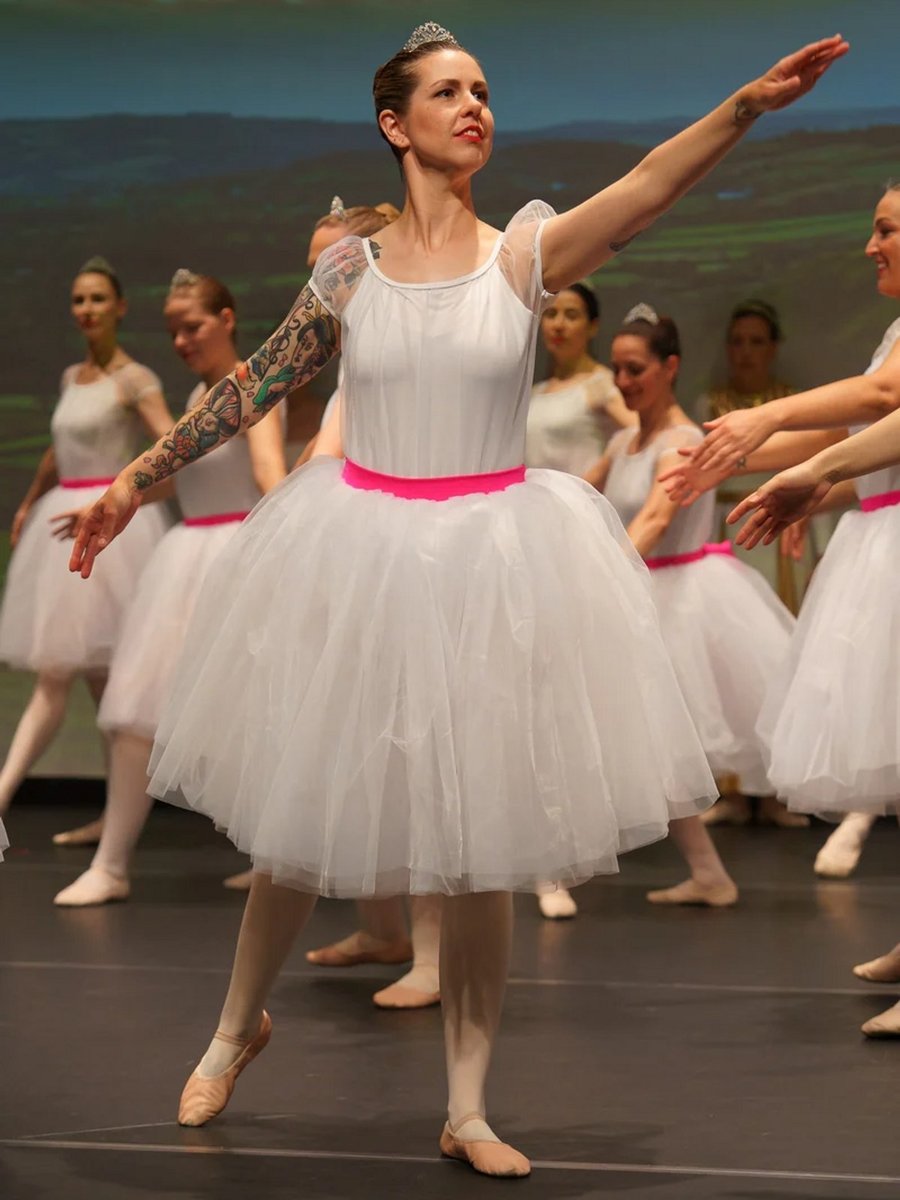 40-year-old woman performing at her ballet concert.