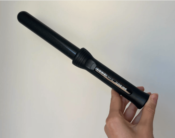 Woman's hand holding CLOUD NINE The Curling Wand.