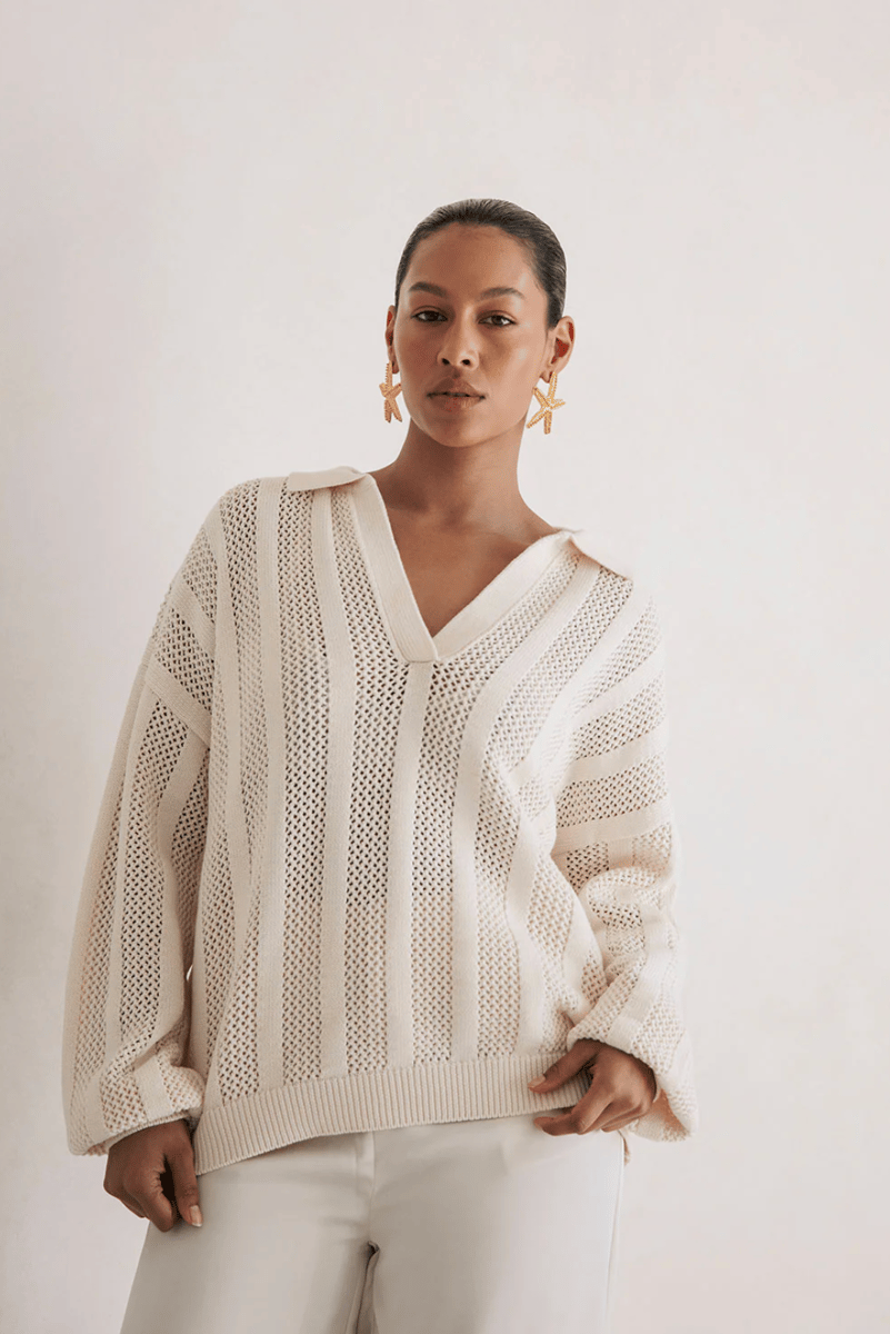 A beige striped cotton knit jumper with a low collar.