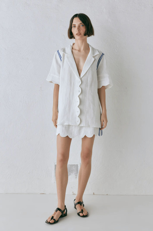 A Vrg Grl white linen set featuring scalloped hemlines and navy blue stripes.