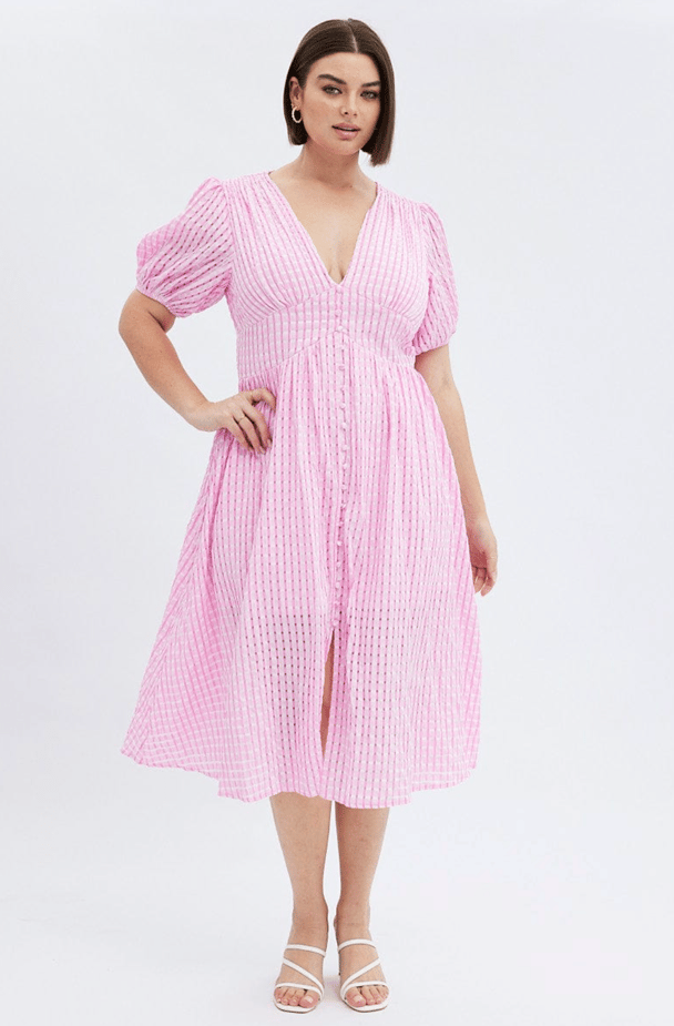 A lightweight pink checked dress with a v-neck and short puff sleeves.