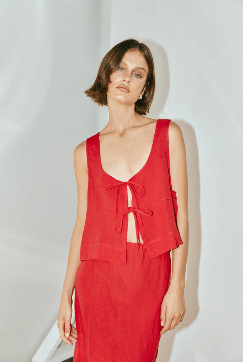 A red linen smock top with ties, and matching red midi skirt.