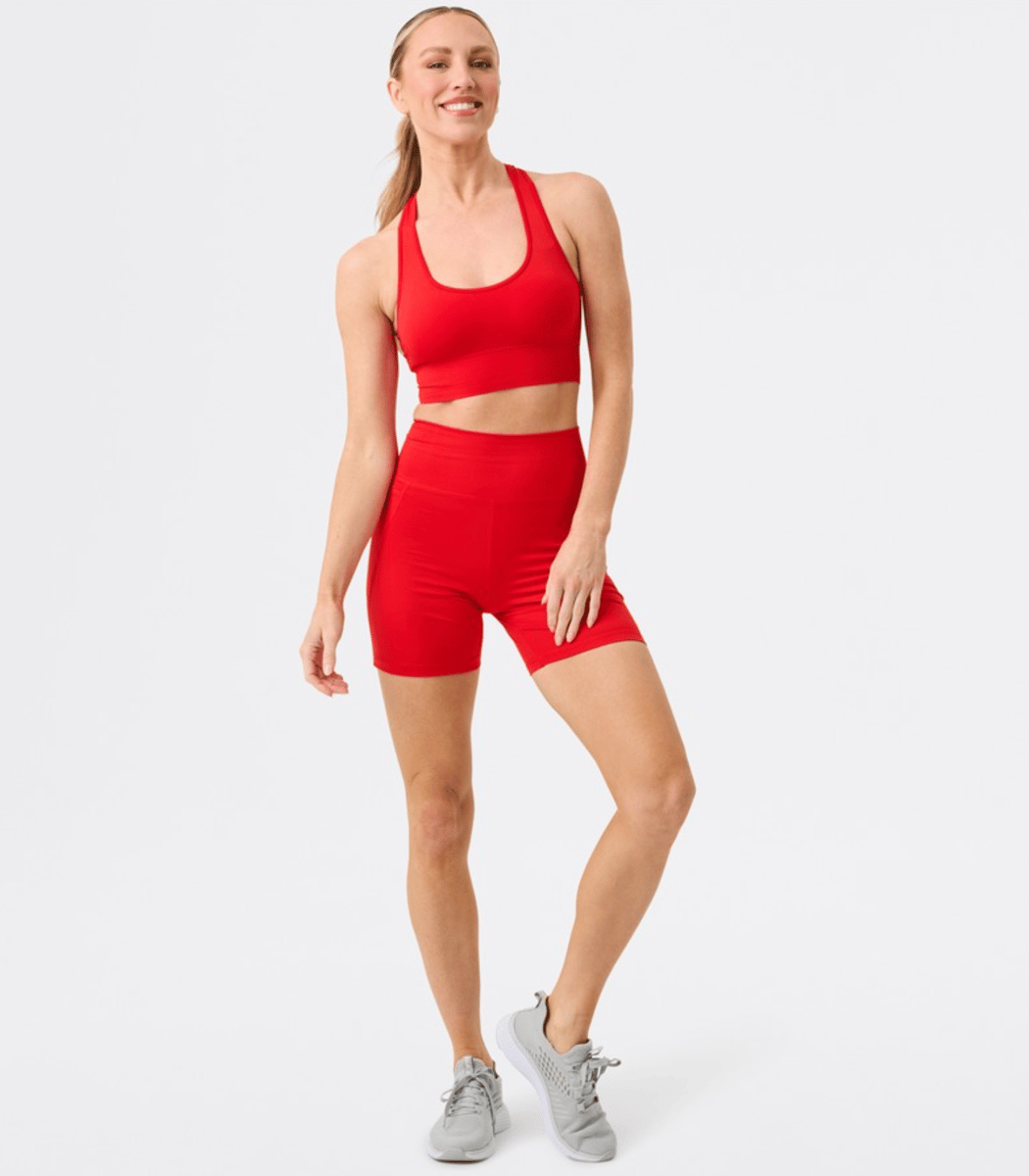 A bright red active crop top and matching bike shorts.