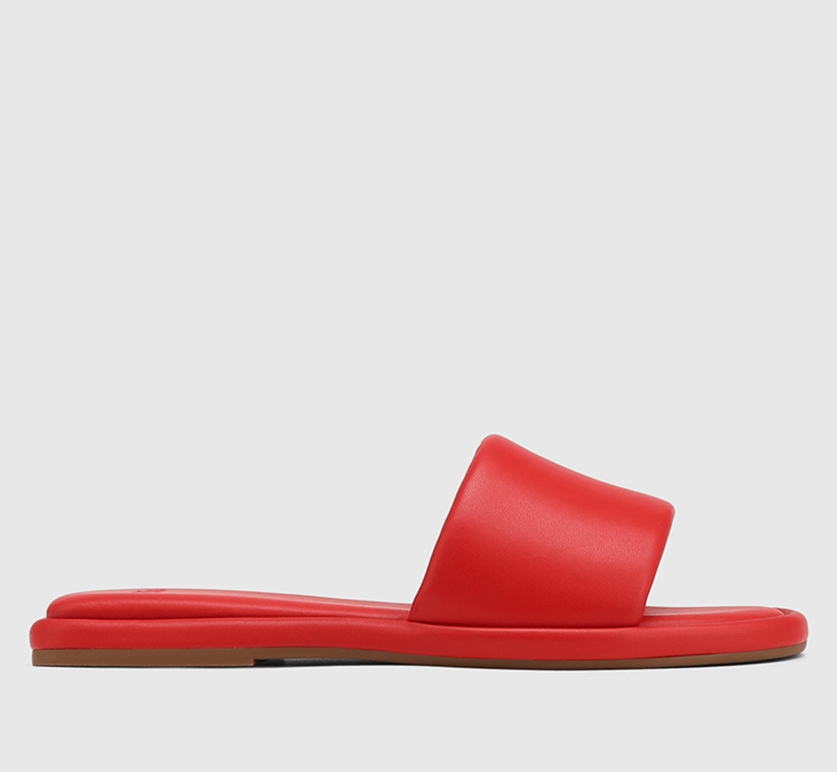 A pair of red leather backless slides.