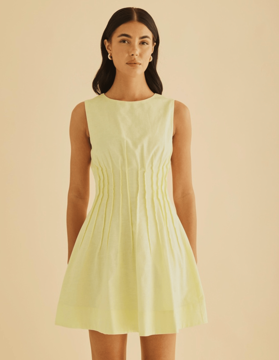 A lemon coloured minidress in linen, with a nipped-in waist.