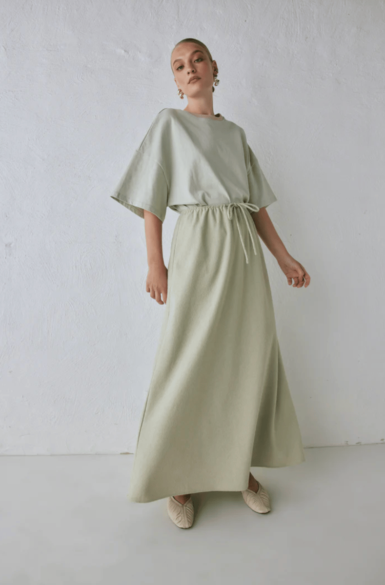 A pistachio green maxi skirt with matching t-shirt.
