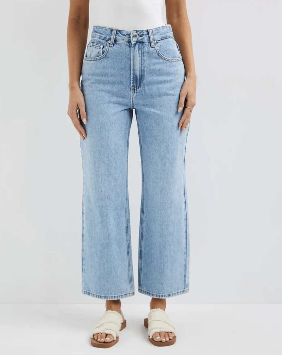 A pair of straight leg blue cropped jeans.