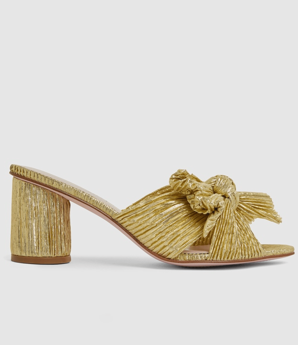 Gold tone pleated fabric shoes with a cylindrical high heel and bow on the front.