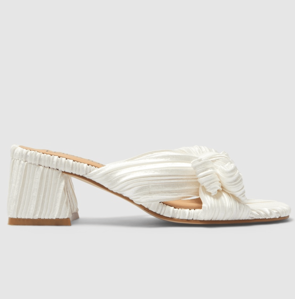 Ivory pleated fabric shoes with a cylindrical high heel and bow on the front.