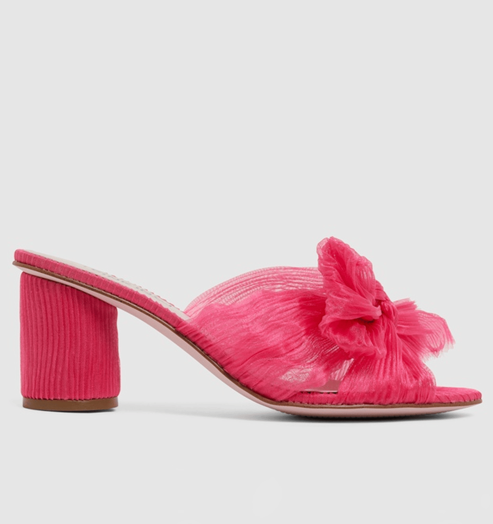 Hot pink pleated fabric shoes with a cylindrical high heel and bow on the front.