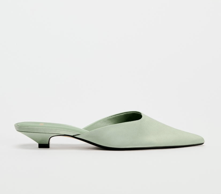 A pair of sage green kitten heel backless pointy shoes.