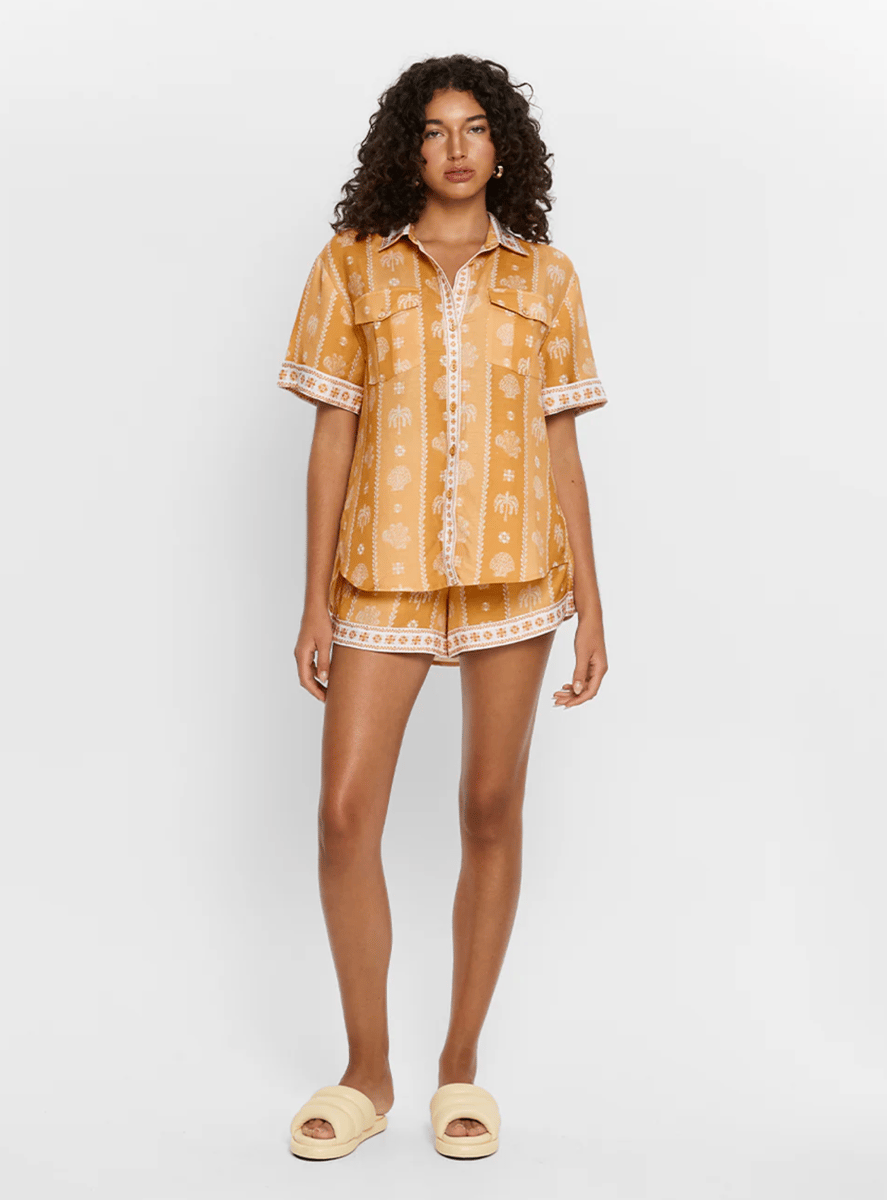 A burnt orange printed shorts and shirt set.