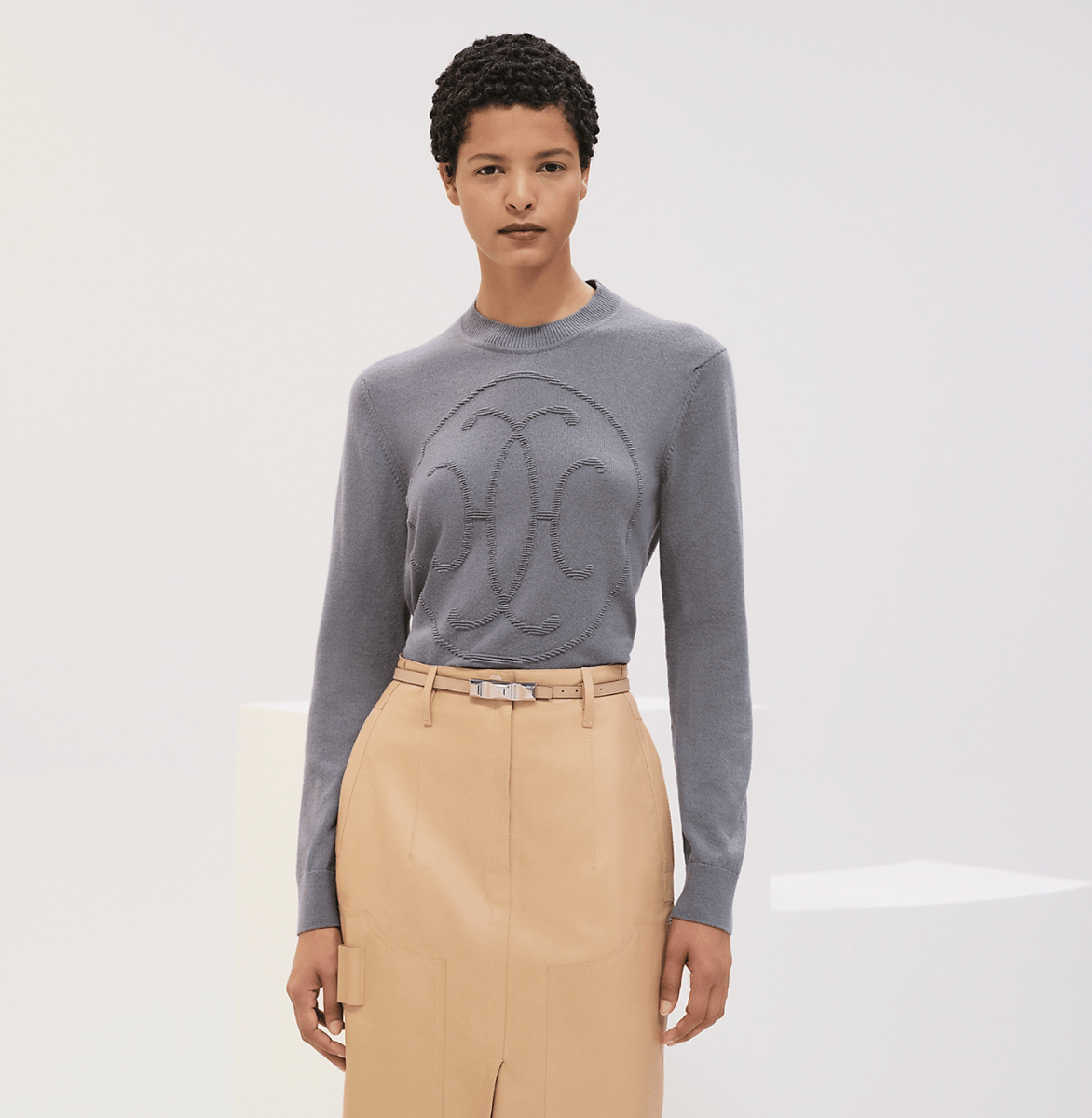 An embossed grey cashmere sweater by Hermes.