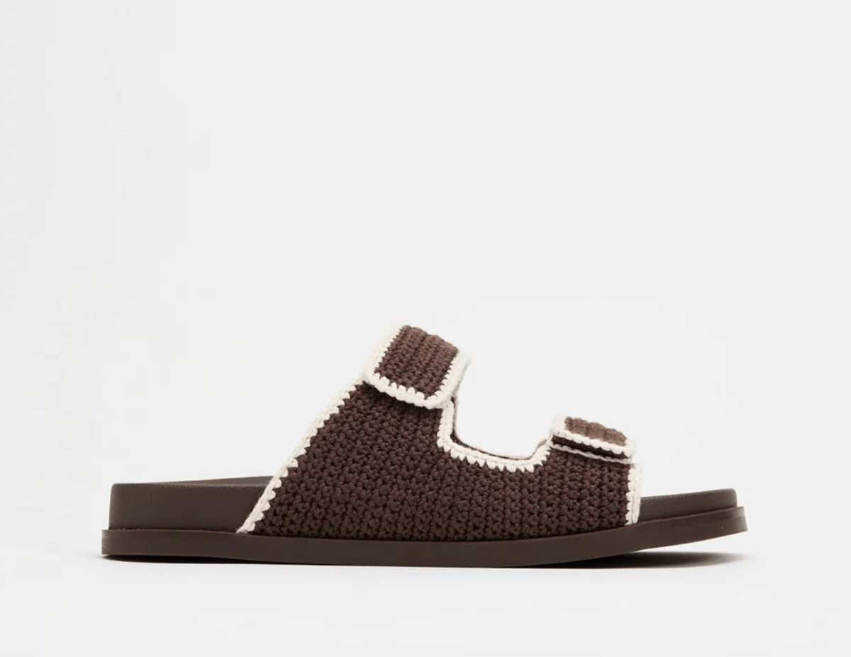 Brown crochet slides with white trim.