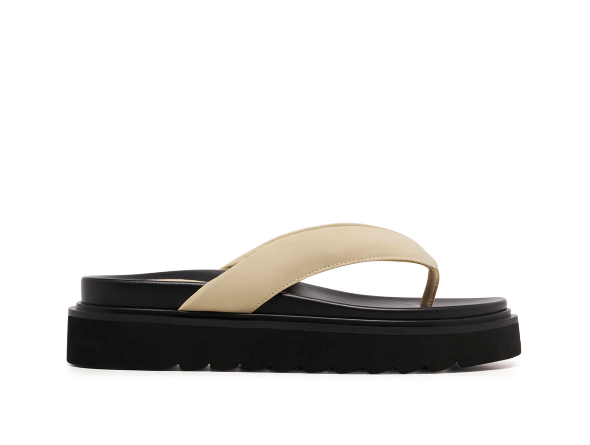 A white flatform flip flop shoe.