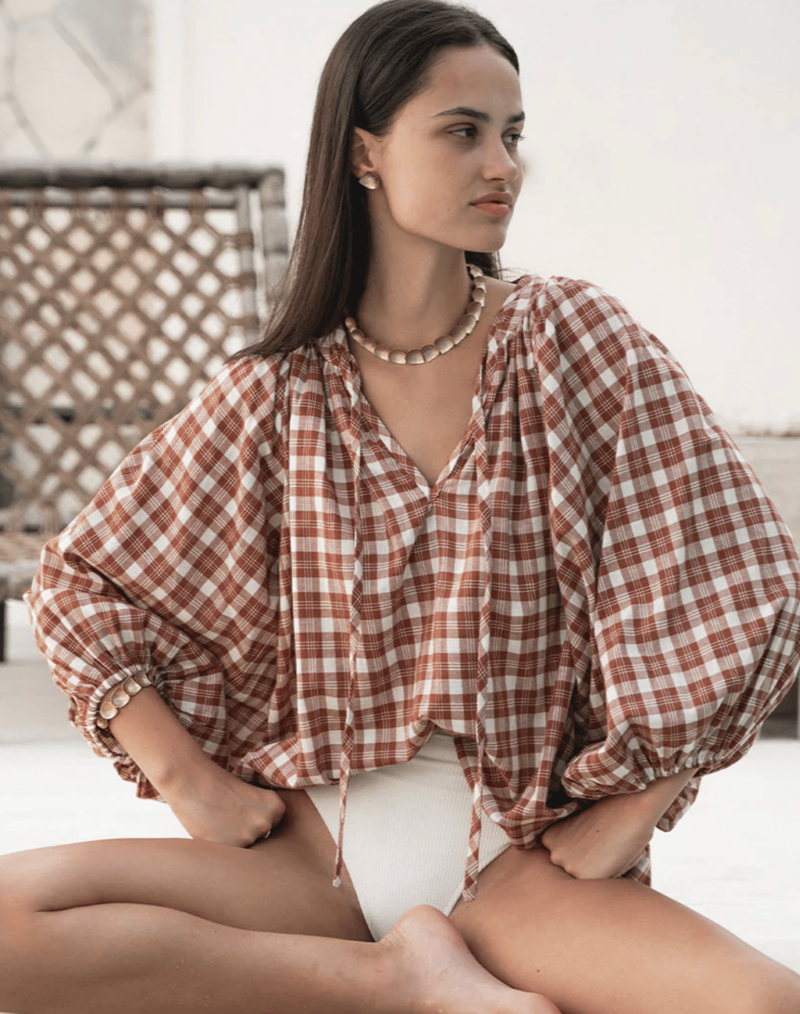 A gingham blouse with voluminous sleeves.