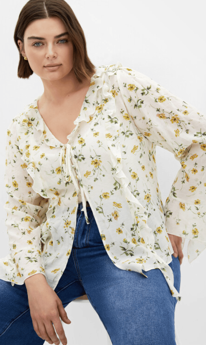 A blouse with small yellow flower print and ruffle detail.