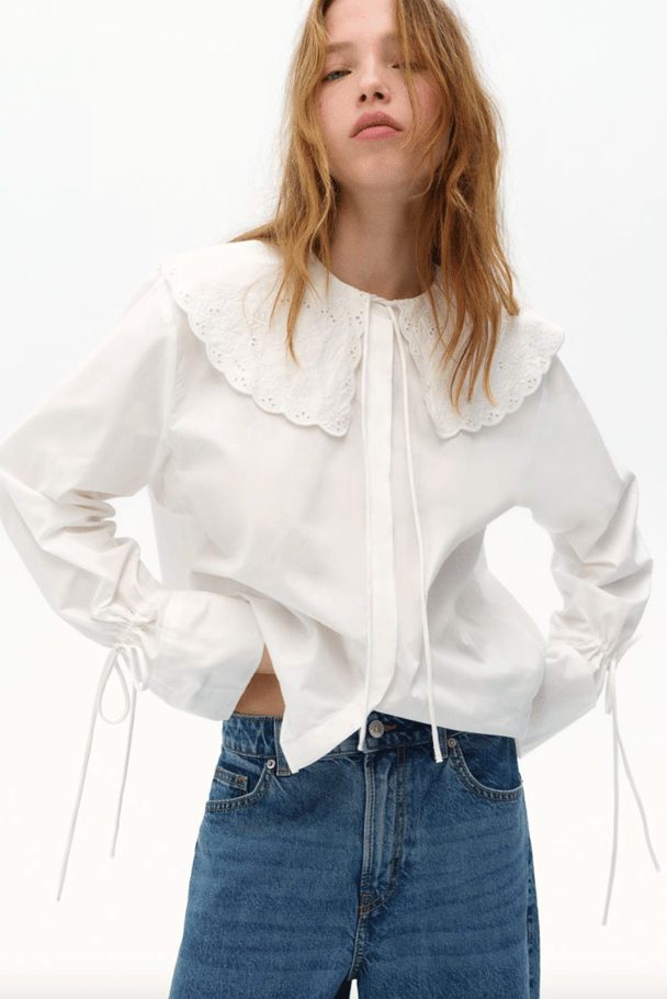 A white blouse with statement lace neckline.