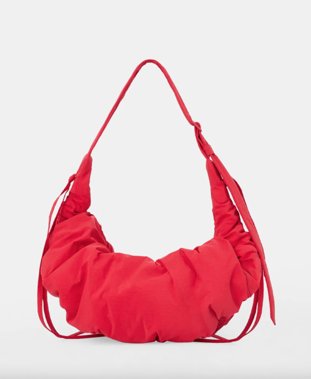 A red nylon slouchy shoulder bag.