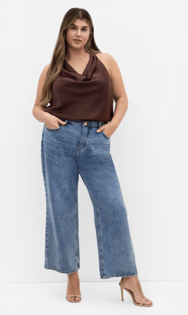 Model wears a chocolate brown cowl neck top in silky fabric.