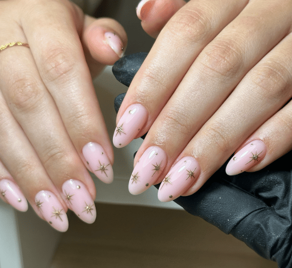 Manicure with gold star design.